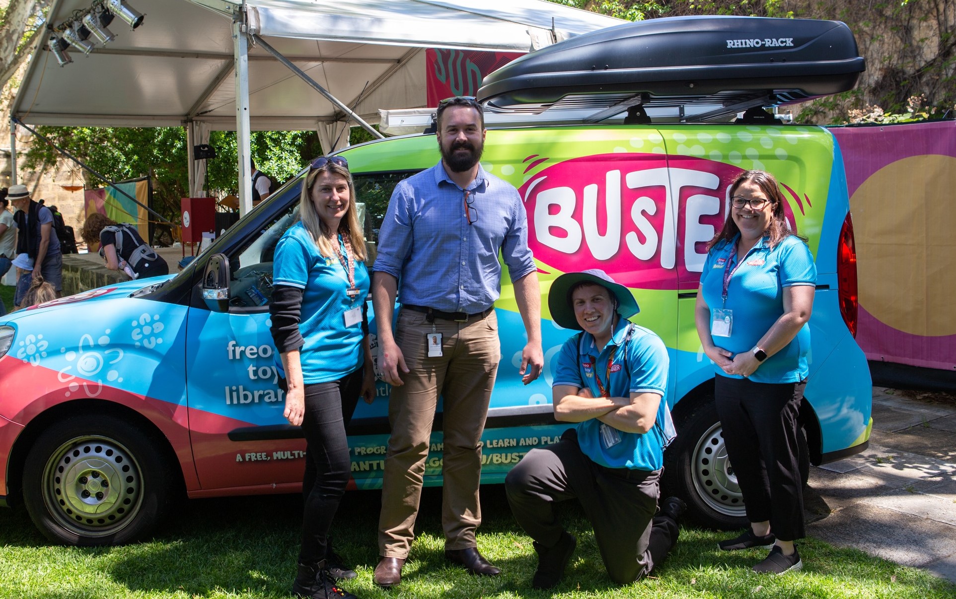 Four people standing in front of the Buster van.