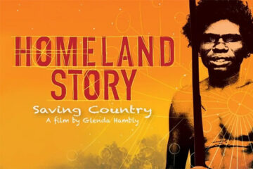 Film poster for Homeland Story: Saving Country shows an Indigenous Australian man holding a spear, set against an orange and yellow background with white circular patterns. Text credits Glenda Hambly as the filmmaker.