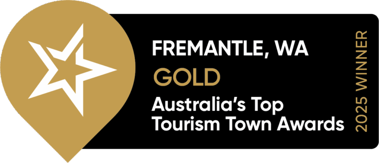 Gold and black badge reading “Fremantle, WA Gold Australia’s Top Tourism Town Awards 2025 Winner,” with a gold map pin and white star on the left side.