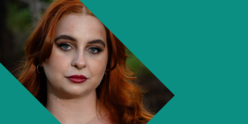 A person with long red hair, bold makeup, and a neutral expression looks at the camera. The photo is partially covered by a teal geometric shape on the right side.