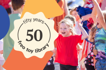 Smiling children play outside at a celebration. Overlaid text reads: fifty years, 50, freo toy library. Bright colors and festive atmosphere suggest a joyful event.